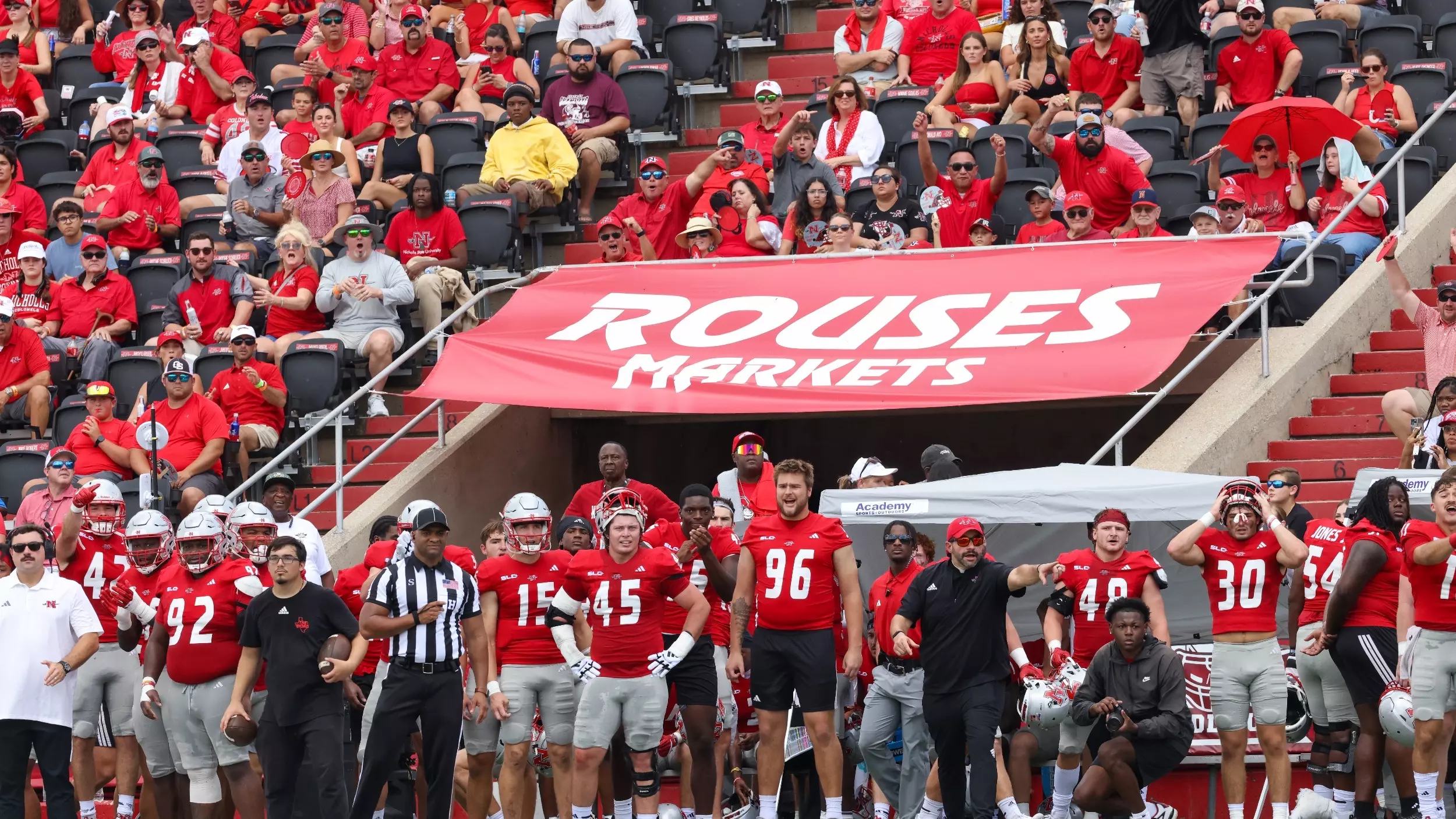 Rutgers football players and fans on the sideline